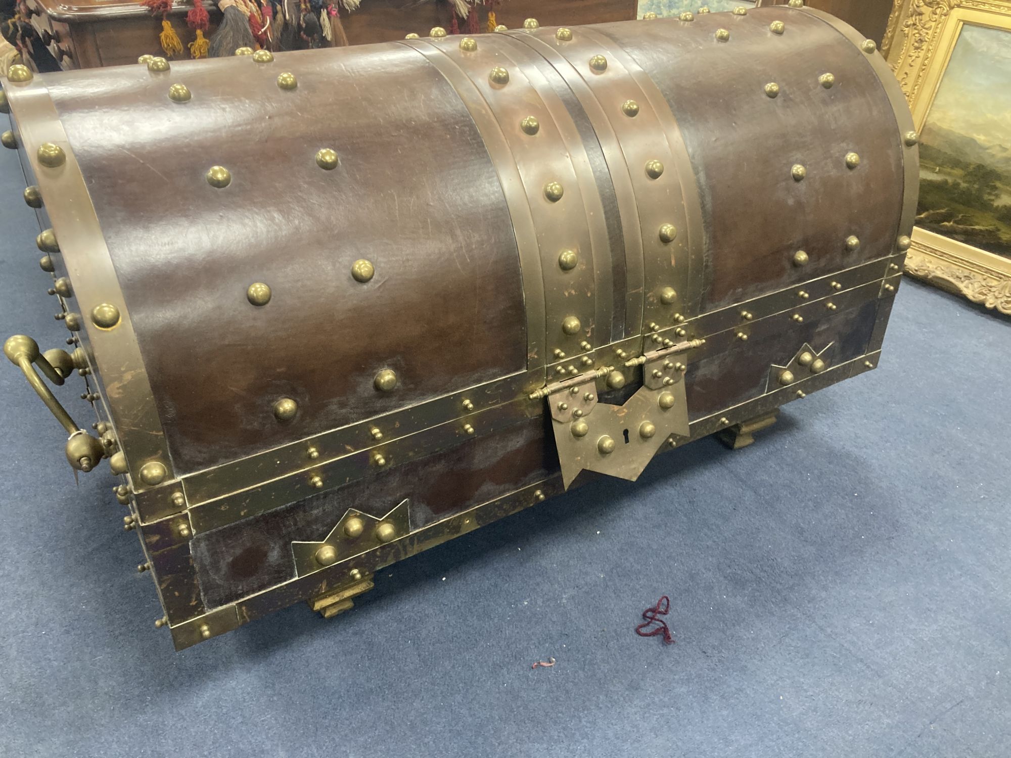 An ormolu and brass mounted leather dome top coffer,